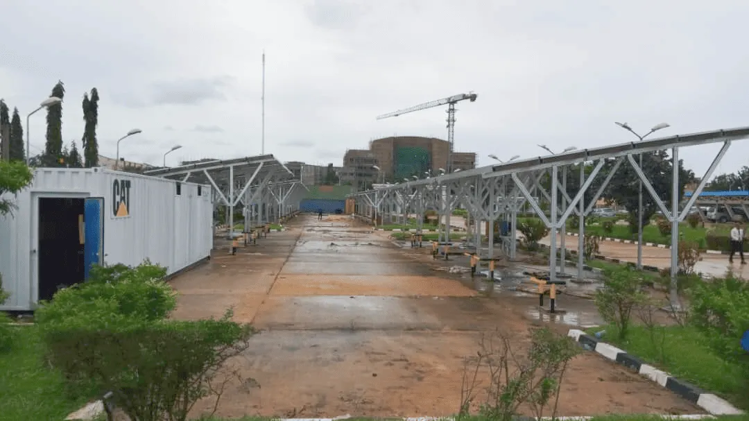 On-site construction of a parking lot solar canopy, showcasing the structural framework and installation process.