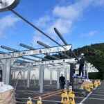 Single-post commercial solar carport structure installed over parking spaces