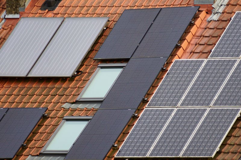 Close-up of solar panels on a tiled roof, showcasing to mount solar panels on a roof rack.
